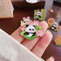 Cute cartoon panda enamel pin featuring pink lotus flowers for backpacks and apparel - Panda Lotus (008)