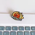 Detailed view of a flame basketball enamel pin with FASTBREAR text on laptop keys - Fastbreak Orange Red Style (D-Model)
