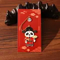 Cute panda metal bookmark in traditional Chinese costume with red gift card background. - Steadily Rising