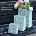 Set of three floral oil painting paper gift bags with handles in different sizes - Small (15.5x14x7cm) / Teal Blue