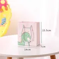 Charming pink paper gift bag featuring a cartoon dinosaur and rope handles, 14x7x15.5cm size - Small (15.5x14x7cm) / Cartoon Dinosaur