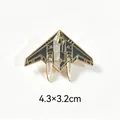 Close-up of stealth fighter jet metal enamel pin with dimensions 4.3x3.2cm for jacket - B-2 Spirit