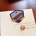 Detailed macro view of a military aircraft carrier enamel pin on a white jewelry gift box - 076 Amphibious Assault Ship