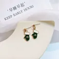 Detail of green enamel Christmas mitten earrings with 925 silver needles and snowflake - Christmas Mittens
