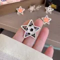 Macro view of a five-pointed star enamel brooch featuring a soccer ball design - Pentagram Football Style (XZ566215) / Football