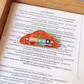 Primer plano de un pin de esmalte naranja con forma de nube y rastreador de ánimo - Estilo Nube / Naranja