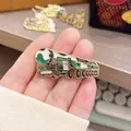 Close-up of a DF-41 intercontinental ballistic missile launcher metal enamel pin badge held by hand. - DF-41 Missile Vehicle