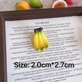 Close-up macro detail of a 3D resin banana brooch with 2.0cm by 2.7cm dimensions - Banana