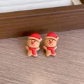 Adorable Christmas gingerbread man earrings featuring a festive red hat and scarf detail - Gingerbread Man A (YJ89651) / Clip-On Earrings