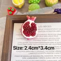 Detailed macro shot of a cute handmade resin pomegranate fruit brooch badge accessory - Peeled Pomegranate B