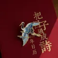 Elegant Chinese style crane enamel brooch with clouds on a red textured background. - Crane Longevity