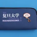Close-up detail of a basketball hoop and ball enamel brooch on a blue fabric pouch. - Basketball Hoop