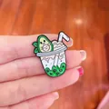 Close-up of a cute avocado bubble tea enamel pin with vibrant green and white colors - Avocado Tea