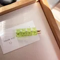 Charming transparent light green gummy bear hair clip set on a golden metal base - Solid Green
