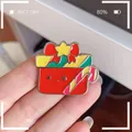 Detailed close-up of a cute red Christmas gift box enamel pin with a candy cane. - Gift Box