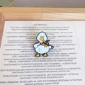 Detailed macro shot of a cute cartoon white duck playing the violin enamel metal pin - Violin Duck