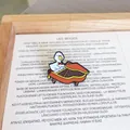 Detailed macro view of a cute enamel pin featuring a white duck playing a piano - Piano Duck