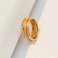 Close-up of minimalist rose gold triple-interlocking ring with a frosted band texture. - US Size 5 / Rose Gold
