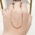 Detail of 18K rose gold snake chain necklace with elegant gold beads on hand. - Bead Chain Necklace (8331) / Rose Gold