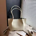 Elegant cream-colored textured tote bag for women, minimalist large capacity commuter style - Yellow
