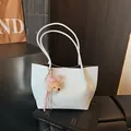 Elegant white faux leather tote bag with a pink bear charm for women's daily commute. - White With Pendant