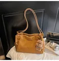 Detailed view of camel suede tote bag featuring plush teddy bear charm and soft texture - With Pendant / Khaki