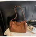 Close-up of brown suede tote bag featuring embossed MIKAXIQI logo in a lifestyle setting. - No Pendant / Brown
