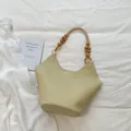 Elegant cream faux leather tote bag with unique wooden bead handle and side hollow details - Tote Bag Style (YL1205) / Yellow