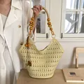 Elegant beige hollow-out tote bag with artistic wooden bead handles for daily use - Tote Bag Style With Ornament (YL1205) / Yellow