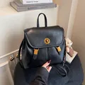 Casual black soft leather backpack for women with golden twist lock and commuter style - With Pendant / Black