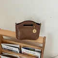 Vintage brown faux leather crossbody bag with a unique circular gold charm detail - No Pendant / Brown