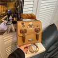 Lindo bolso mochila marrón con diseño de dibujos animados y asa de felpa suave - Caqui