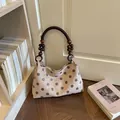 Elegant vintage beige polka dot bucket shoulder bag featuring a decorative wooden bead handle - Khaki