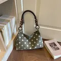 Stylish green polka dot suede shoulder bag featuring a unique wooden bead handle design. - Green