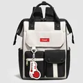 Modern black and white nylon backpack featuring multiple pockets and a trendy red charm - Black