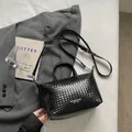 Black woven leather tote bag for women with top handles and shoulder strap. - Black