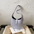 Minimalist lavender crescent shoulder bag with adjustable strap in a lifestyle setting - No Pendant / Purple
