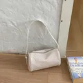 Stylish vintage woven barrel bag in cream white with a slim adjustable shoulder strap - White