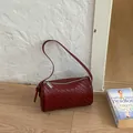 Vintage burgundy woven barrel shoulder bag with stylish textured finish - Red