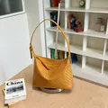 Sophisticated yellow woven texture underarm bag featuring a modern pillow shape design - Yellow