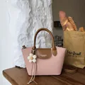Vintage pink canvas handbag for women featuring brown leather trim and flower charm - With Flower Pendant / Pink