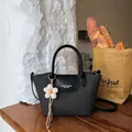 Elegant vintage black tote bag with top handle and flower charm for stylish women - With Flower Pendant / Black