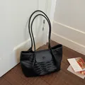 Classic black woven leather tote bag for women featuring large capacity and soft straps - Black