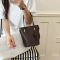 Stylish dark brown woven bucket handbag for women with elegant handle and small pouch - Coffee