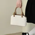 Elegant off-white bucket handbag with stylish knotted tan handles for summer - No Pendant / Off White