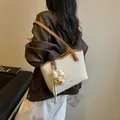 Elegant canvas and brown faux leather tote shoulder bag featuring a cute bear charm - Off White