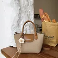 Retro minimalist khaki canvas handbag with brown leather trim and flower charm accessory - With Flower Pendant / Khaki