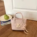 Schattige roze gewatteerde emmer tas met konijn charm en hartvormige parelmoer strik - Roze Klein