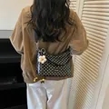 Stylish black and white polka dot bucket bag featuring a decorative white flower charm - Black with Pendant