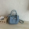 Stylish blue textured bucket handbag with sturdy top handles and adjustable shoulder strap - No Pendant / Blue